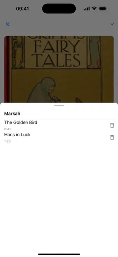Daftar penanda di pemutar audiobuku Fablum pada iPhone: dua penanda bernama bab, “The Golden Bird” di 0:41 dan “Hans in Luck” di 1:23, masing-masing dengan tombol hapus